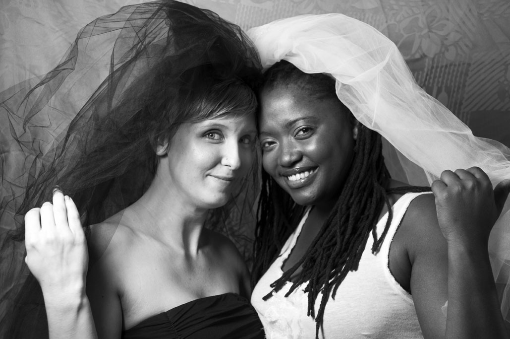 b&w brides veils up looking out 72